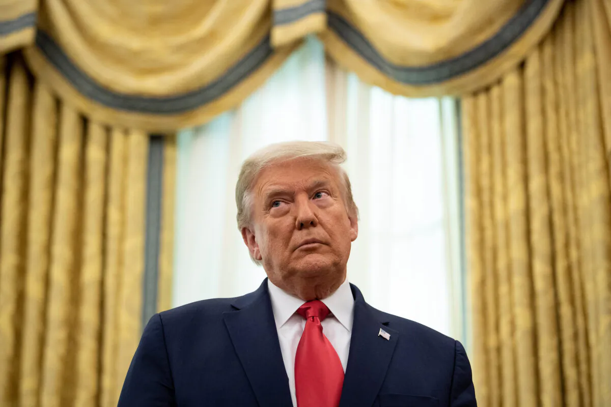 President Donald Trump listens during a Medal of Freedom ceremony for Lou Holtz in the Oval Office of the White House on Dec. 3, 2020. (Brendan Smialowski/AFP via Getty Images)