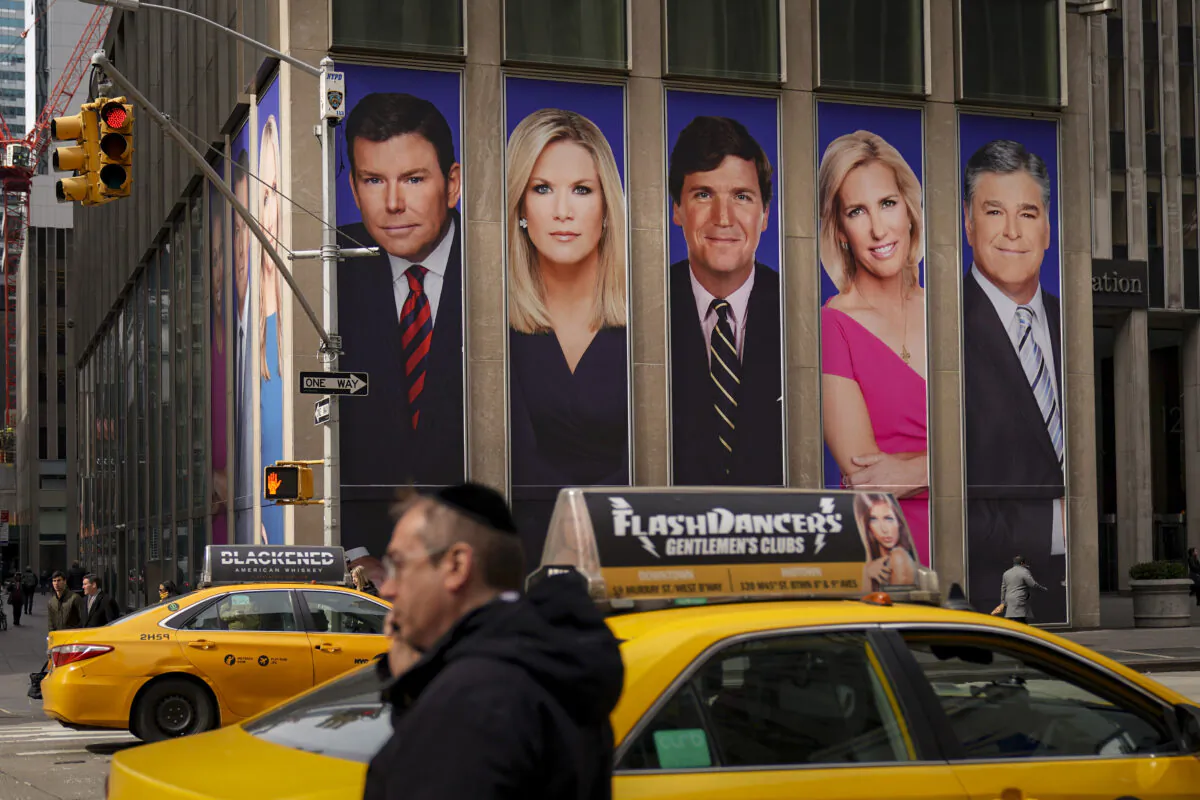 An advertisement features Fox News personalities, including Tucker Carlson and Sean Hannity, in New York, on March 13, 2019. (Drew Angerer/Getty Images)