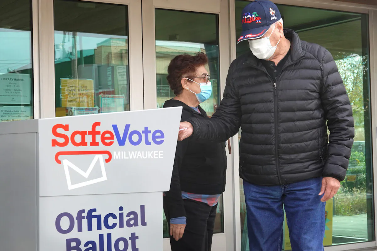 Residents drop mail-in ballots in a ballot box outside of the Tippecanoe branch library in Milwaukee, Wis., on Oct. 20, 2020. (Scott Olson/Getty Images)