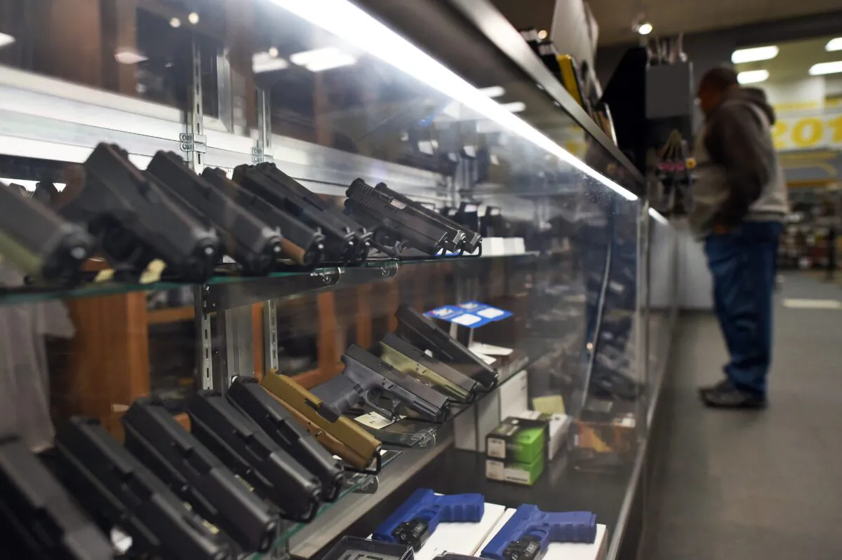A man looks at handguns at a shooting range in Randolph, N.J., on Dec. 9, 2015. (Jewel Samad/AFP via Getty Images)