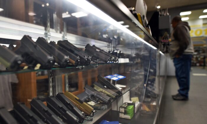 A man looks at handguns at a shooting range in Randolph, N.J., on Dec. 9, 2015. (Jewel Samad/AFP via Getty Images)