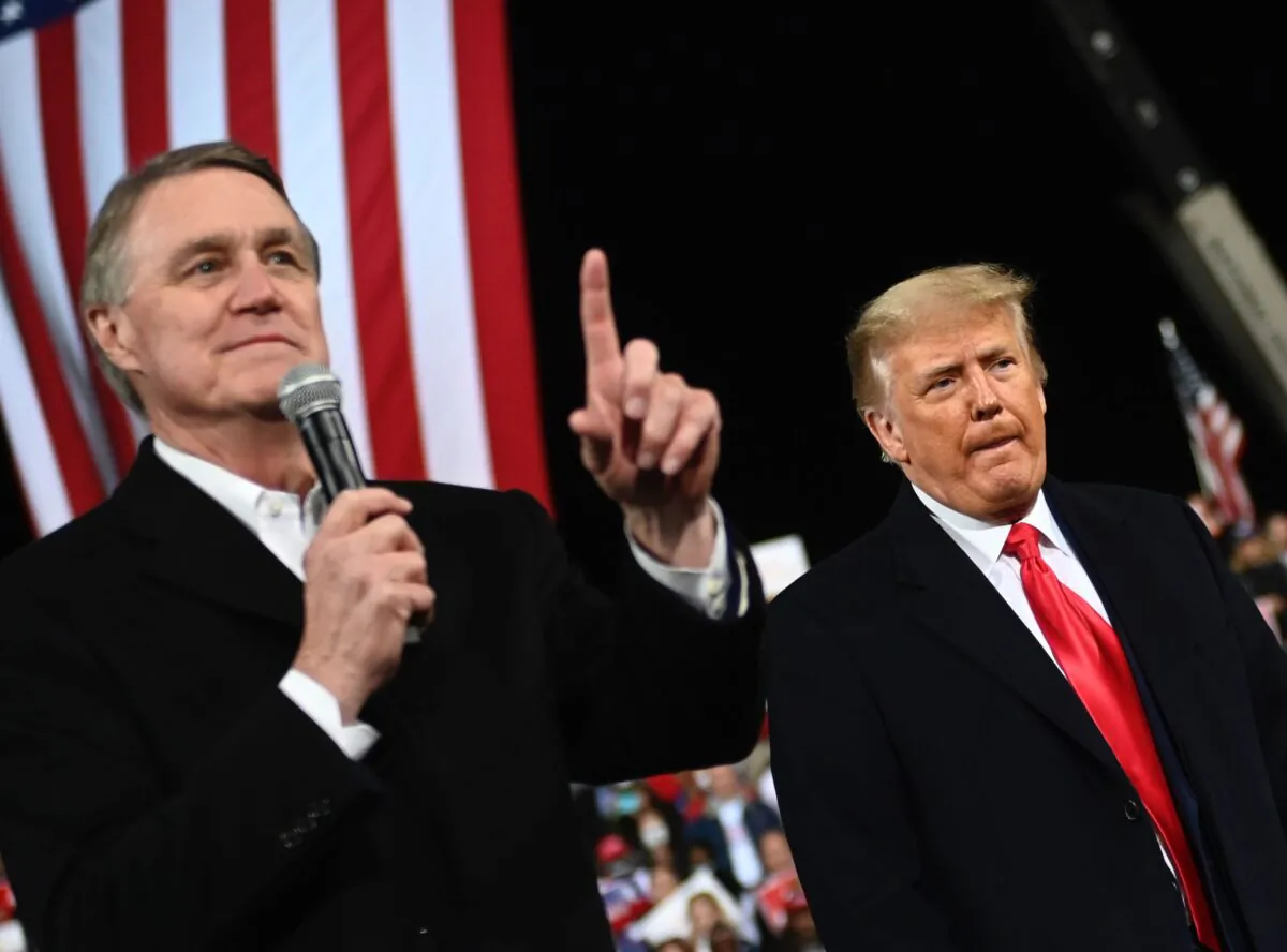 Sen. David Perdue (R-Ga.) next to President Donald Trump during a rally at Valdosta Regional Airport in Valdosta, Ga., on Dec. 5, 2020. (Andrew Caballero-Reynolds/AFP via Getty Images)