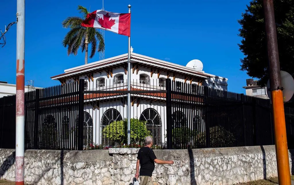 In this April 17, 2018 file photo, a man walks beside Canada's embassy in Havana, Cuba. (AP Photo/Desmond Boylan, File)
