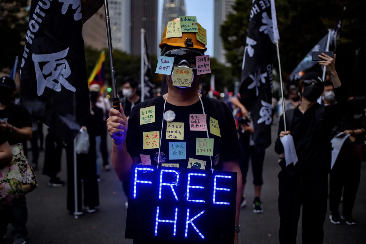 An activist dresses as a human "Lennon Wall" before an anti-China protest to mark the 71st anniversary of the founding of the People's Republic of China in Shinjuku district of Tokyo on October 3, 2020. (Philip Fong/AFP via Getty Images)