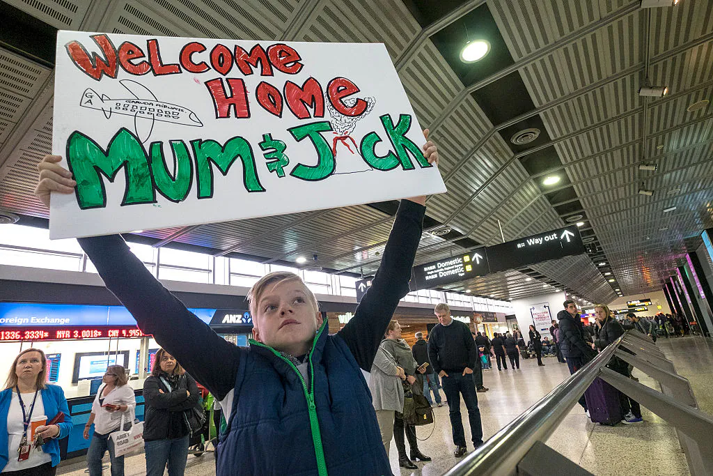 Kobe Rose (10yrs) waits for his mum's arrival at Melbourne International Airport on July 14, 2015 in Melbourne, Australia. (Luis Ascui/Getty Images)