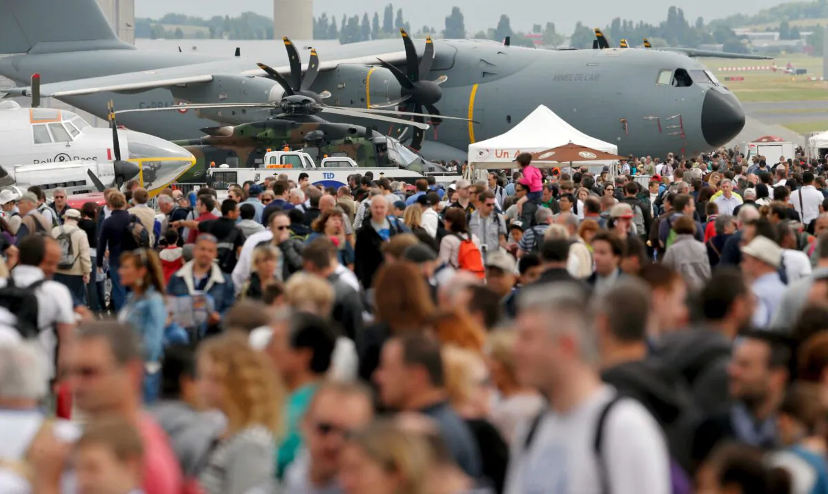 Visitors walk at the static display area during the last day of the 51st Paris Air Show at Le Bourget airport near Paris on June 21, 2015. (Pascal Rossignol/Reuters)