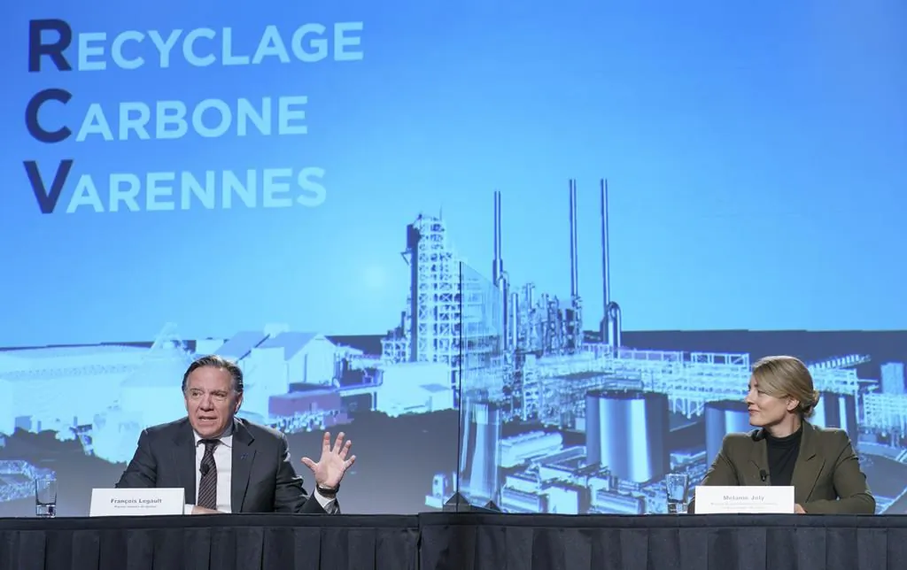 Melanie Joly, Minister of Economic Development and Official Languages, listens to Quebec Premier Francois Legault during a news conference announcing an investment in a biofuels plant, in Montreal, Tuesday, Dec. 8, 2020. (The Canadian Press/Paul Chiasson)