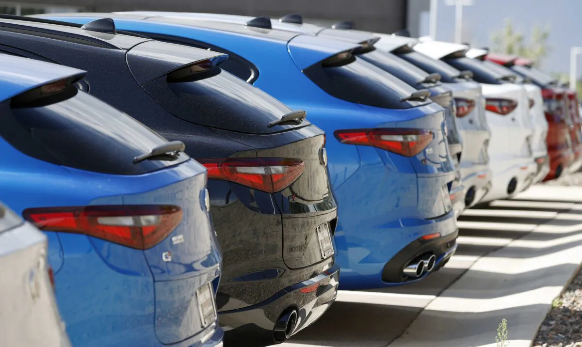 A long row of unsold 2020 Stelvio sports-utility vehicles sits at an Alfa Romeo dealership in Highlands Ranch, Colo., on July 19, 2020. (David Zalubowski/AP Photo)