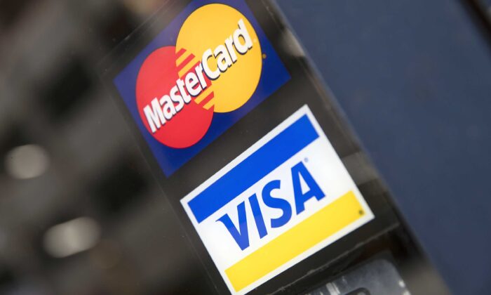 Credit card logos are seen on a store's door in Philadelphia on Nov. 29, 2018. (Matt Rourke/AP Photo)