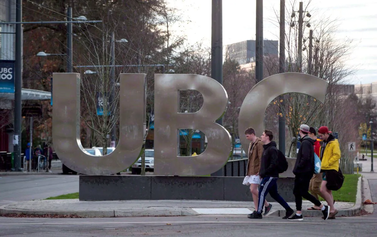 Students walk past the UBC sign at the University of British Columbia in Vancouver, in a file photo. (Darryl Dyck/The Canadian Press)