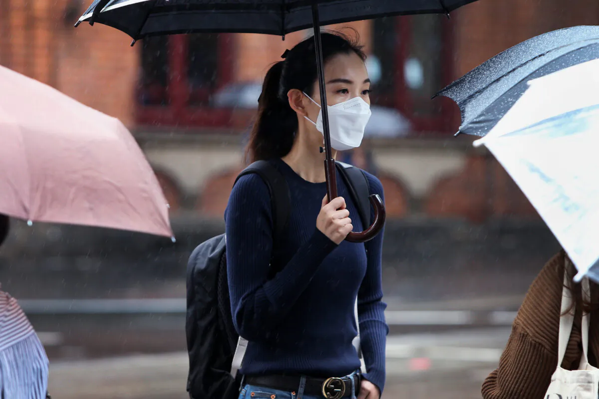 A woman wears a face mask as she walks through the Chinatown district on March 04, 2020 in Sydney, Australia. (Lisa Maree Williams/Getty Images)
