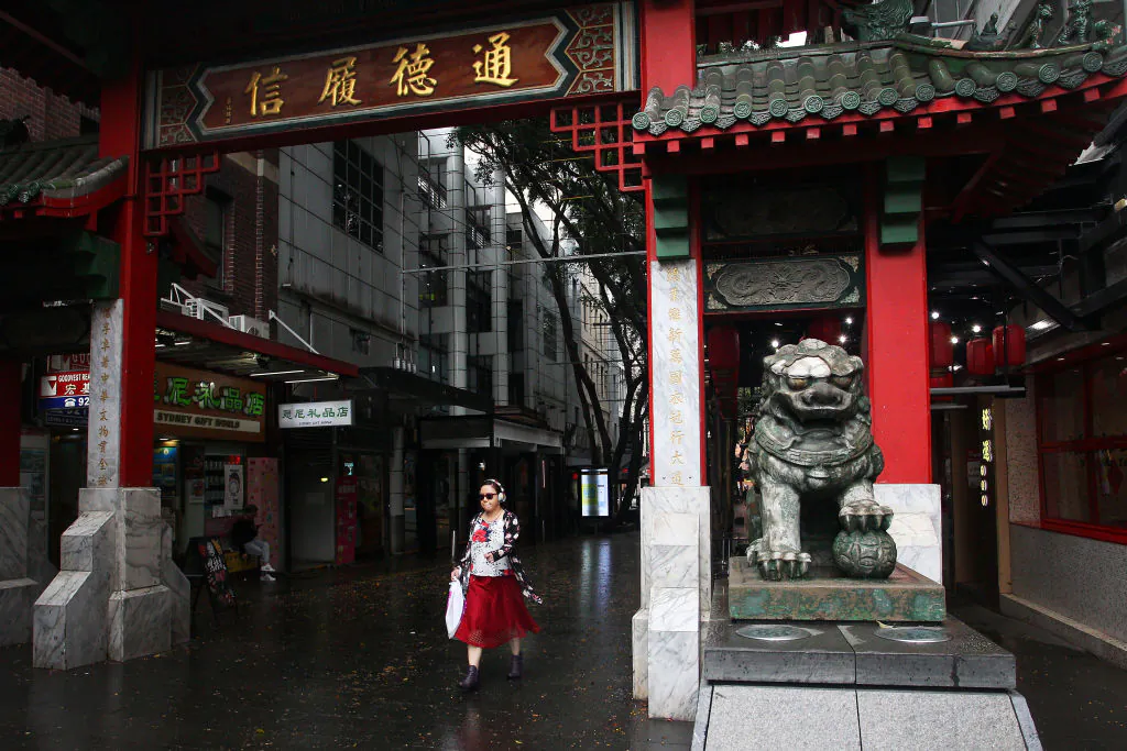 A woman walks through the Chinatown district arch in Sydney on March 4, 2020. (Lisa Maree Williams/Getty Images)