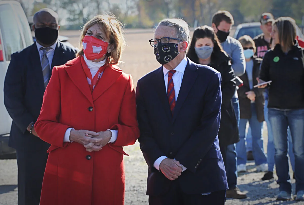 Republican Ohio Gov. Mike DeWine along with his wife Fran, waits in line to vote at the Cedarland Event Center in Cedarville, Ohio, on Nov. 3, 2020. (Marshall Gorby/Dayton Daily News via AP)