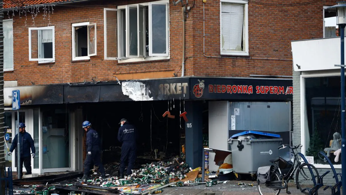 People inspect the debris after an explosion in Aalsmeer, near Amsterdam, Netherlands, on Dec. 8, 2020. (Peter Dejong/AP Photo)