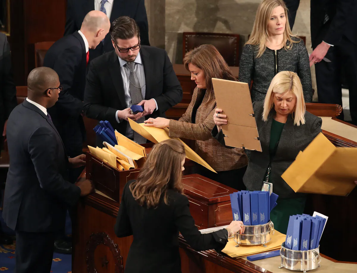 Staffers organize state's ballots during the counting of the electoral votes from the 2016 presidential election during a joint session of Congress in Washington on Jan. 6, 2017. (Mark Wilson/Getty Images)