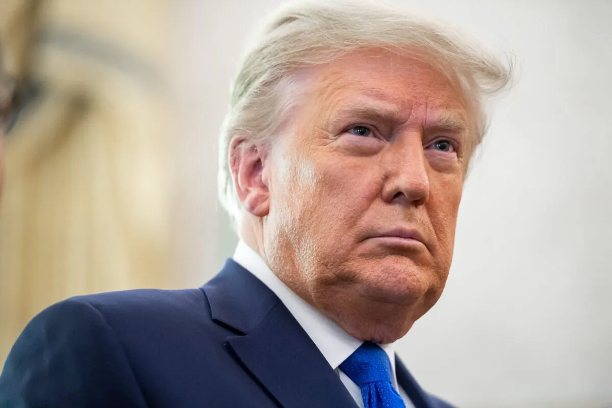 U.S. President Donald Trump looks on during a ceremony presenting the Presidential Medal of Freedom to wrestler Dan Gable in the Oval Office of the White House in Washington on Dec. 7, 2020. (Saul Loeb/AFP via Getty Images)