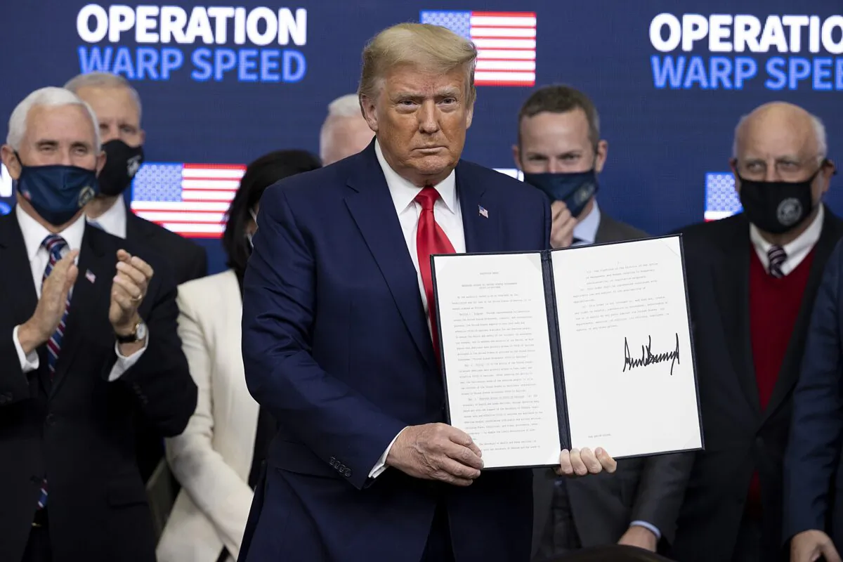 President Donald Trump signed an executive order at the Operation Warp Speed Vaccine Summit in Washington on Dec. 8, 2020. (Tasos Katopodis/Getty Images)