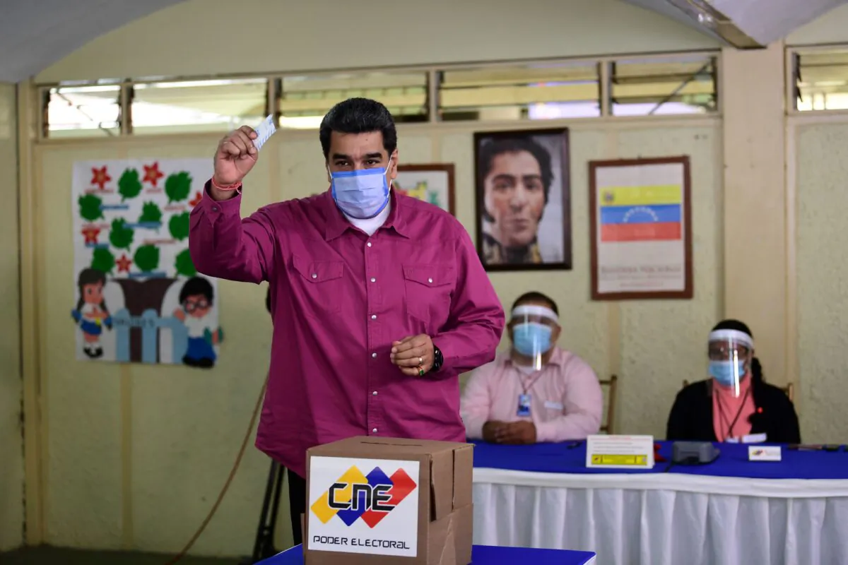 Venezuelan President Nicolas Maduro casts his vote at a polling station in the Simon Rodriguez school in Fuerte Tiuna, Caracas, on Dec. 6, 2020 during Venezuela's legislative elections. (Yuri Cortez/AFP via Getty Images)