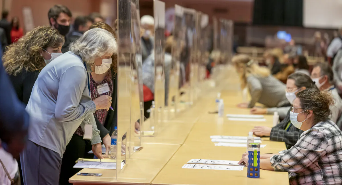 Representatives for President Donald Trump (L) looks over a ballots during the presidential recount vote for Dane County, in Madison, Wis., on Nov. 20, 2020. (Andy Manis/Getty Images)