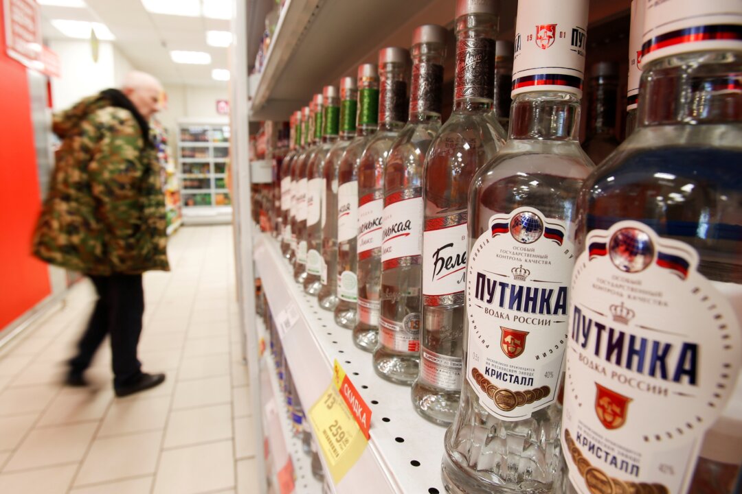 A customer walks past shelves with bottles of vodka in a supermarket amid the COVID-19 pandemic in Moscow, Russia, on April 8, 2020. (Maxim Shemetov/Reurers)