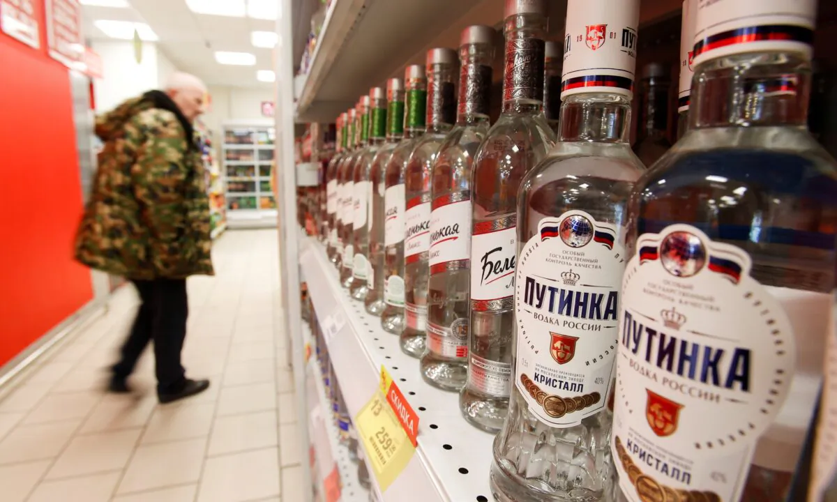A customer walks past shelves with bottles of vodka in a supermarket amid the COVID-19 pandemic in Moscow, Russia, on April 8, 2020. (Maxim Shemetov/Reurers)