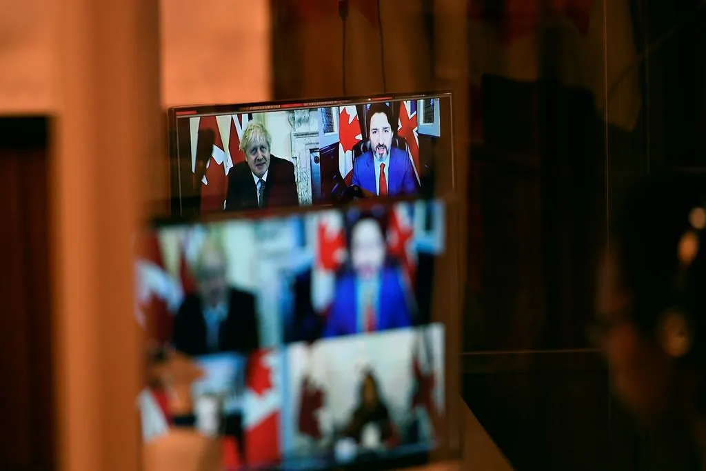 Canadian Prime Minister Justin Trudeau and U.K. Prime Minister Boris Johnson are seen in a pre-recorded video from an earlier videoconference during a news conference on the Canada-United Kingdom Trade Continuity Agreement in Ottawa, on Nov. 21, 2020. (The Canadian Press/Justin Tang)