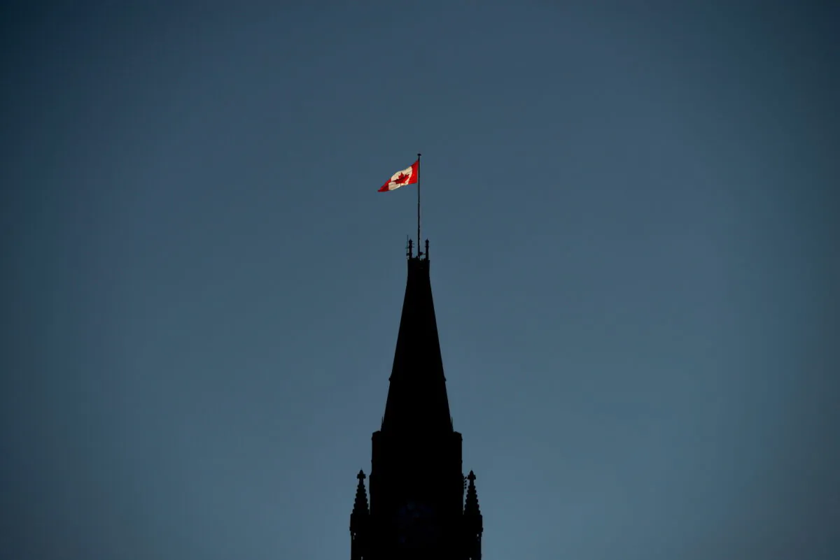 The Canadian Flag is illuminated by morning light atop the Peace Tower on Parliament Hill in Ottawa on Sept. 17, 2018. (Sean Kilpatrick/The Canadian Press)