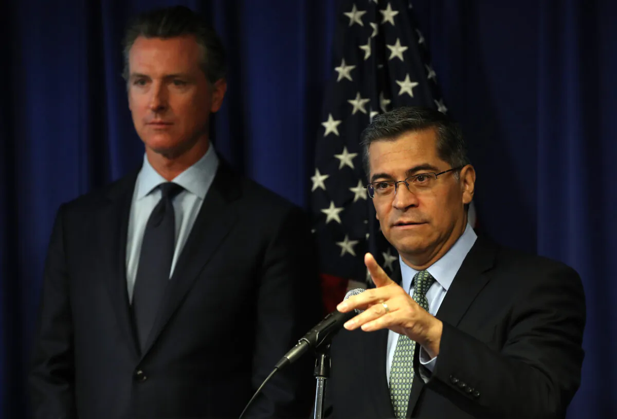 California Attorney General Xavier Becerra (R) speaks as California Gov. Gavin Newsom looks on during a news conference at the California justice department in Sacramento, Calif. on Sept. 18, 2019. (Justin Sullivan/Getty Images)
