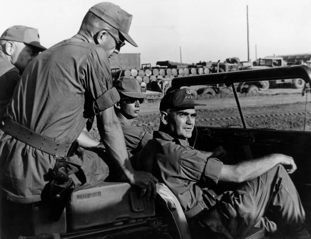 U.S. General William Childs Westmoreland (1914–2005) sitting in a jeep during an inspection of the Mekong Delta base camp of the 9th Infantry Division near Long Thanh, Vietnam War, circa 1966. Sitting atop the jeep behind the general is Colonel James W. Phillips, commander of the 9th Infantry Division Artillery.  (Hulton Archive/Getty Images)