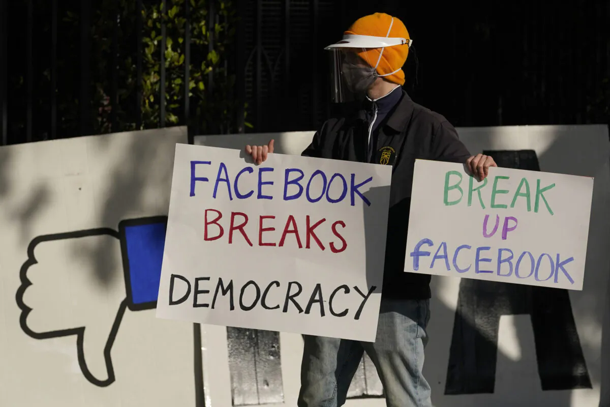 A demonstrator joins others outside of the home of Facebook CEO Mark Zuckerberg to protest what they say is Facebook spreading disinformation in San Francisco on Nov. 21, 2020. (Jeff Chiu, AP Photo, File)