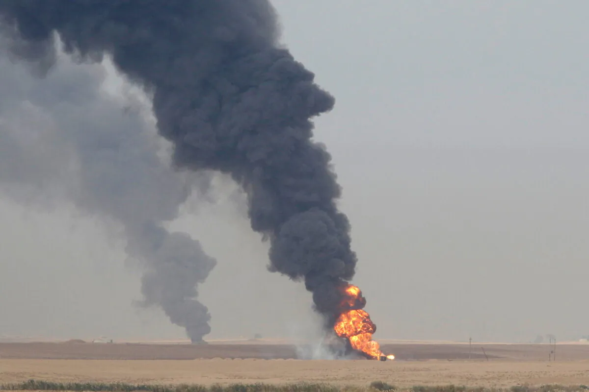 Smoke rises from oil wells inside the Khabbaz oilfield after they were bombed on the outskirts of Kirkuk, Iraq, on Dec. 9, 2020. (Ako Rasheed/Reuters)