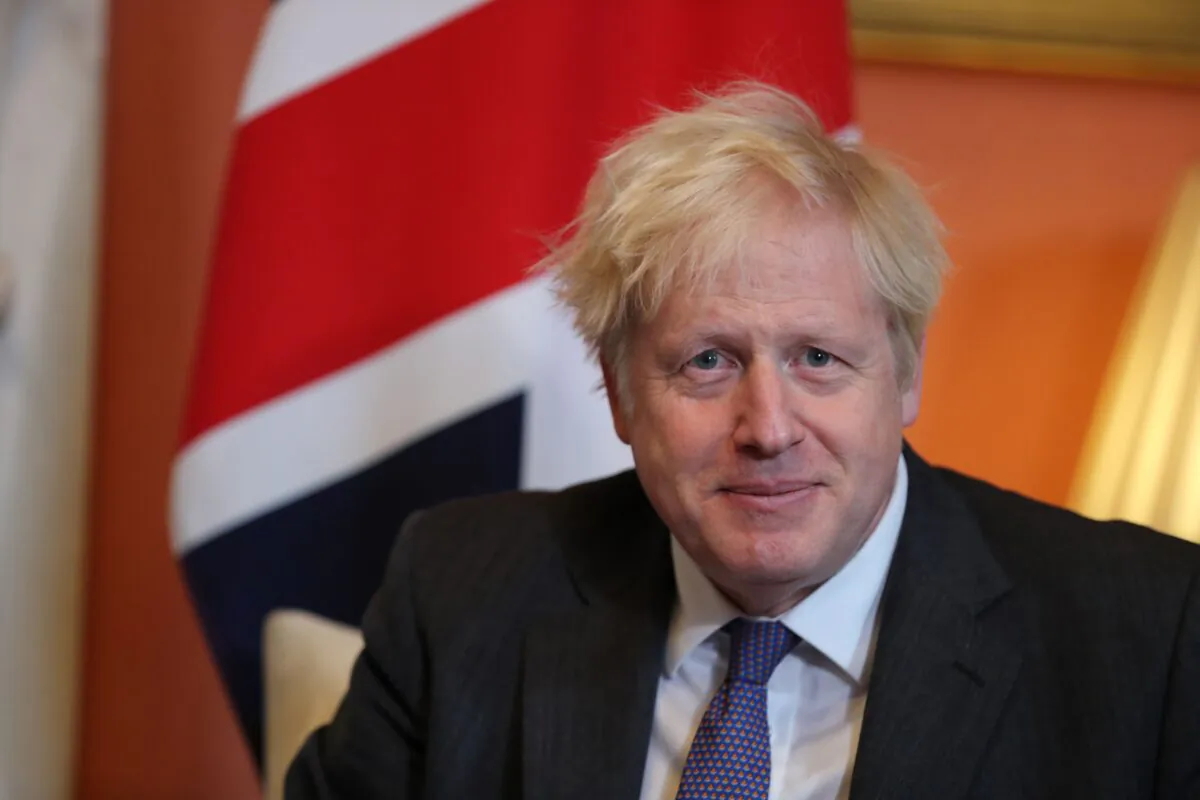 Britain's Prime Minister Boris Johnson sits in front of a Union flag as he talks with Abu Dhabi's Crown Prince Sheikh Mohammed bin Zayed al-Nahyan inside 10 Downing Street in central London, on Dec. 10, 2020. (Gareth Fuller/Pool/AFP via Getty Images)
