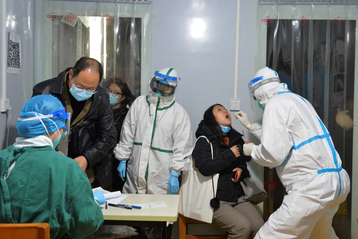 Health workers are conducting nucleic acid tests on residents of Chengdu, China, on Dec. 8, 2020. (STR/AFP via Getty Images)