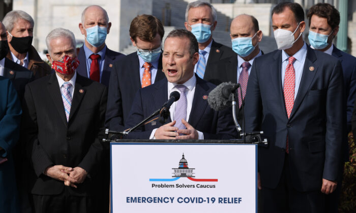 Rep. Josh Gottheimer (D-NJ) (C) and Rep. Tom Reed (R-NY) (3rd R), co-chairs of the bipartisan Problem Solvers Caucus, hold a news conference with fellow members of Congress to highlight the need for bipartisan, bicameral COVID-19 relief legislation outside the U.S. Capitol in Washington on Dec. 03, 2020. (Chip Somodevilla/Getty Images)