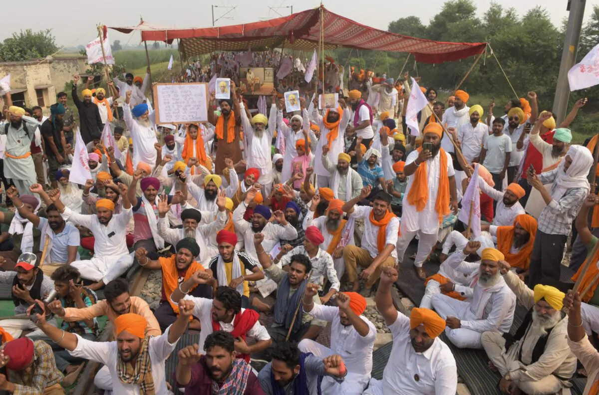 Farmers shout slogans while blocking railway tracks, on the outskirts of Amritsar, during a protest against Indian Prime Minister Narendra Modi's government following the recent passing of new farm bills in parliament, on Sept. 28, 2020. (Narinder Nanu/AFP via Getty Images)
