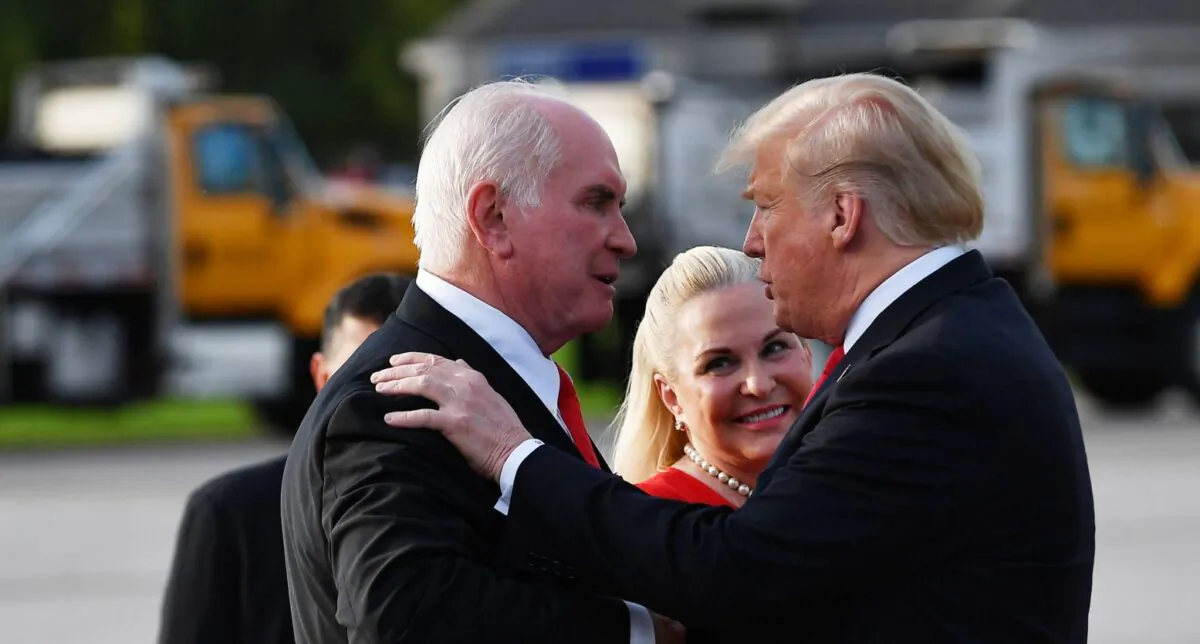 President Donald Trump greets Rep. Mike Kelly and his wife Victoria upon arrival at Erie International Airport in Erie, Pennsylvania on October 10, 2018. (Photo by MANDEL NGAN / AFP)