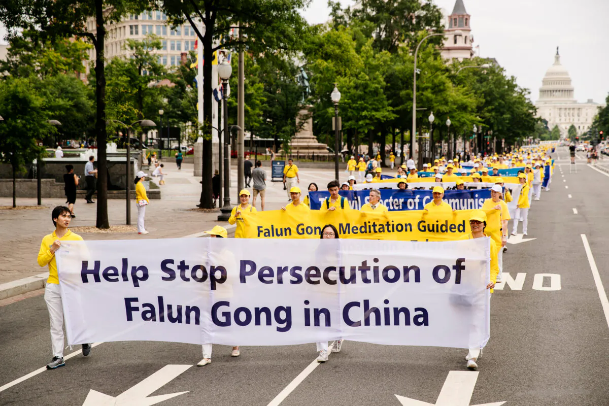 Local Falun Gong practitioners take part in a grand march calling for an end to the persecution of the spiritual practice in China, on June 20, 2018, in Washington (Edward Dye/The Epoch Times)