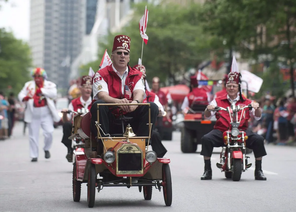 Members of the Shriners entertain the crowd as they participate in the annual Canada Day parade in Montreal. (The Canadian Press/Graham Hughes)