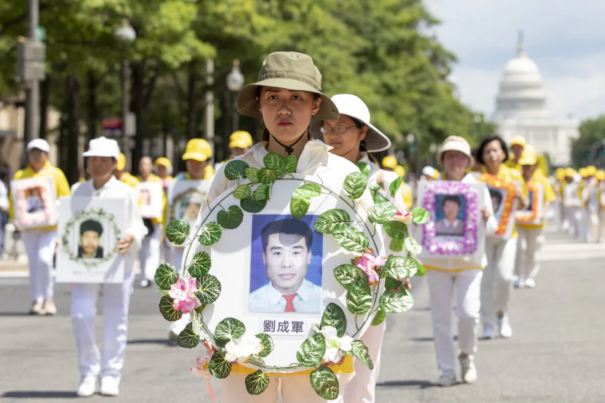Falun Gong practitioners take part in a parade commemorating the 20th anniversary of the persecution of Falun Gong in China, in Washington on July 18, 2019. (Samira Bouaou/The Epoch Times)