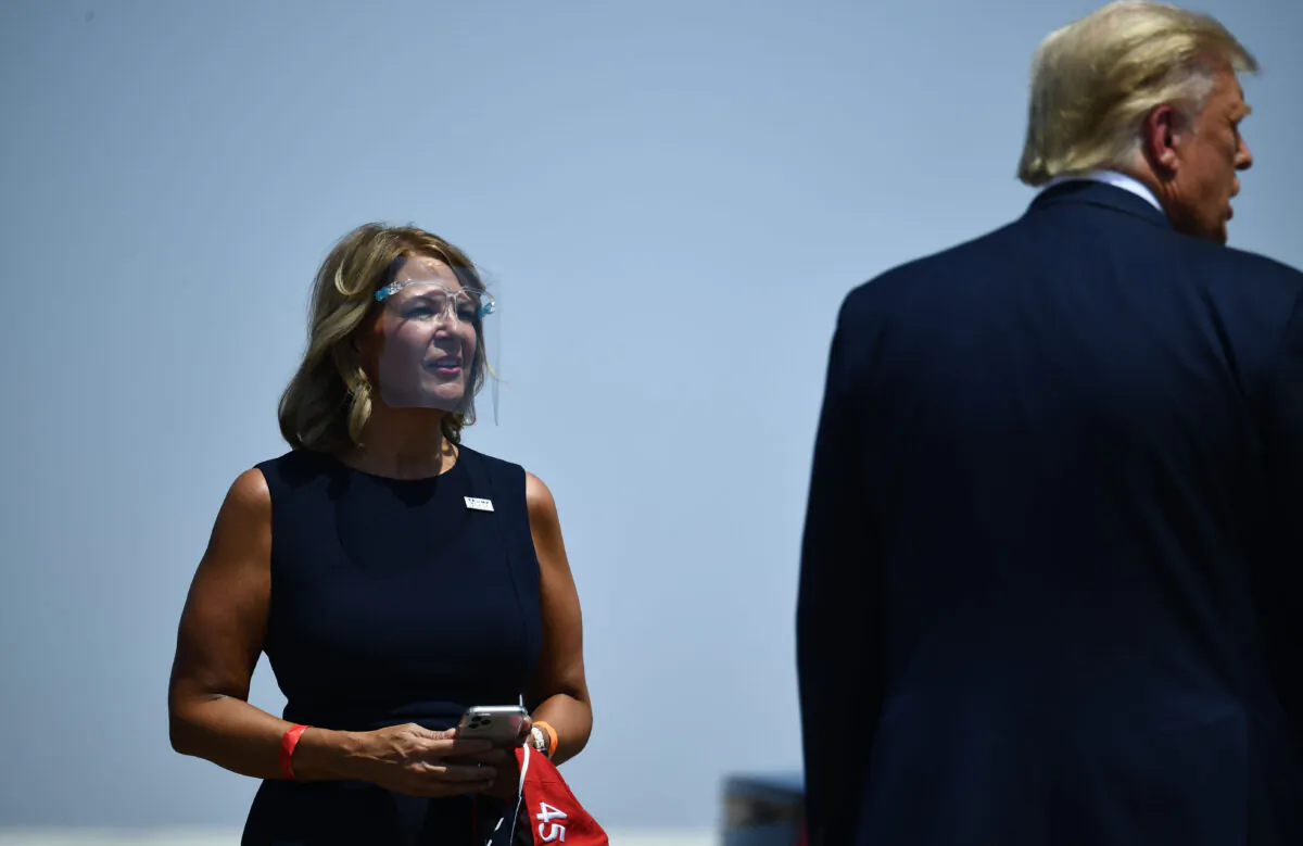 US President Donald Trump (R) is greeted by the Chairwoman of the Arizona Republican Party Kelli Ward as he arrives to deliver remarks on immigration and border security at the international airport in Yuma, Arizona on Aug. 18, 2020. (Brendan Smialowski/AFP via Getty Images)