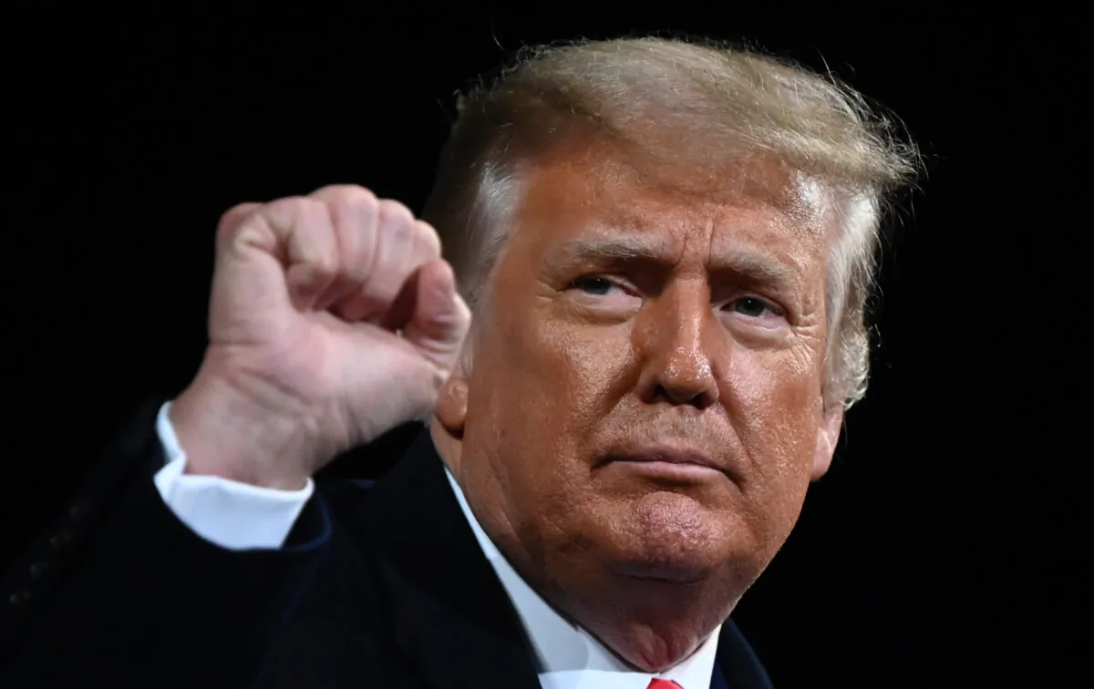 President Donald Trump raises his fist at the end of a rally to support Republican Senate candidates at Valdosta Regional Airport in Valdosta, Ga., on Dec. 5, 2020. (Andrew Caballero-Reynolds/AFP via Getty Images)