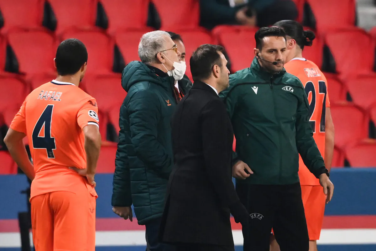Istanbul Basaksehir's Turkish coach Okan Buruk (2ndR) talks to Romanian 4th referee Sebastian Coltescu (R) after the game was suspended in the first half as the players walked off amid allegations of racism by one of the match officials during the UEFA Champions League group H football match between Paris Saint-Germain (PSG) and Istanbul Basaksehir FK at the Parc des Princes stadium in Paris, on Dec. 8, 2020. 
(Franck Fife/AFP via Getty Images)