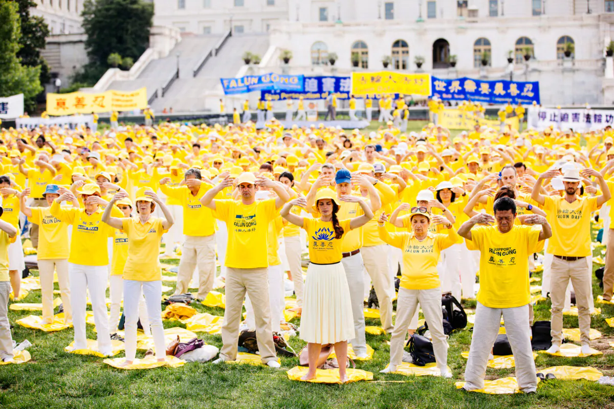 Falun Gong practitioners take part in a rally calling for an end to the persecution of Falun Gong in China, on Capitol Hill in Washington, on June 20, 2018. (Edward Dye/The Epoch Times)
