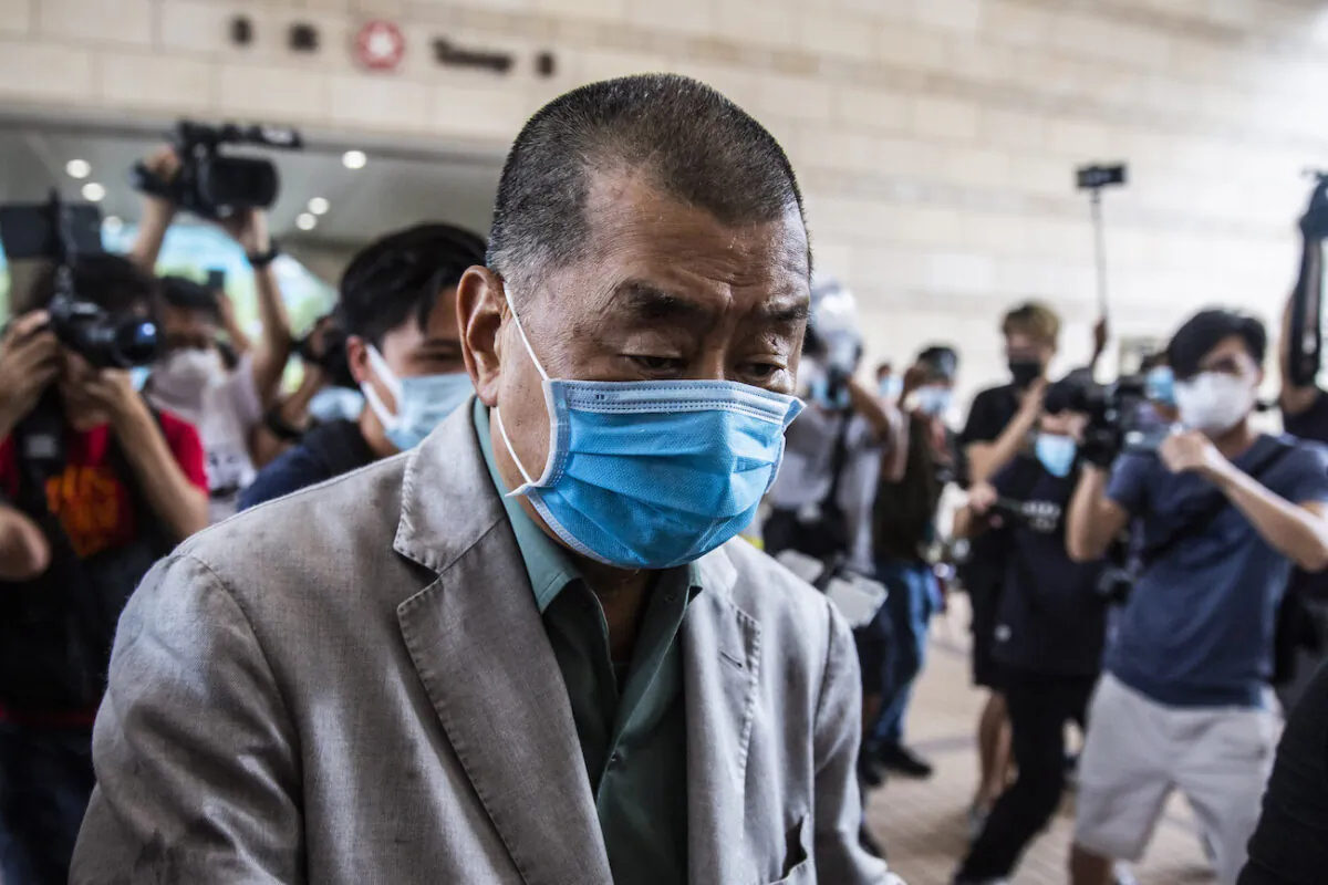 Hong Kong pro-democracy media mogul Jimmy Lai pushes through a media pack as he arrives at the West Kowloon court in Hong Kong on Sept. 3, 2020. (Isaac Lawrence/AFP via Getty Images)