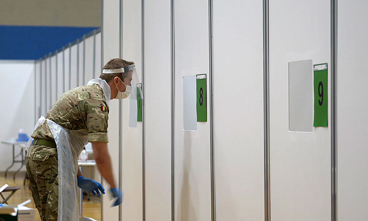 A soldier conducting CCP virus tests on members of the public at a testing centre at Croxteth Sports Centre in Liverpool, England, on Nov. 7, 2020.  (Christopher Furlong/Getty Images)