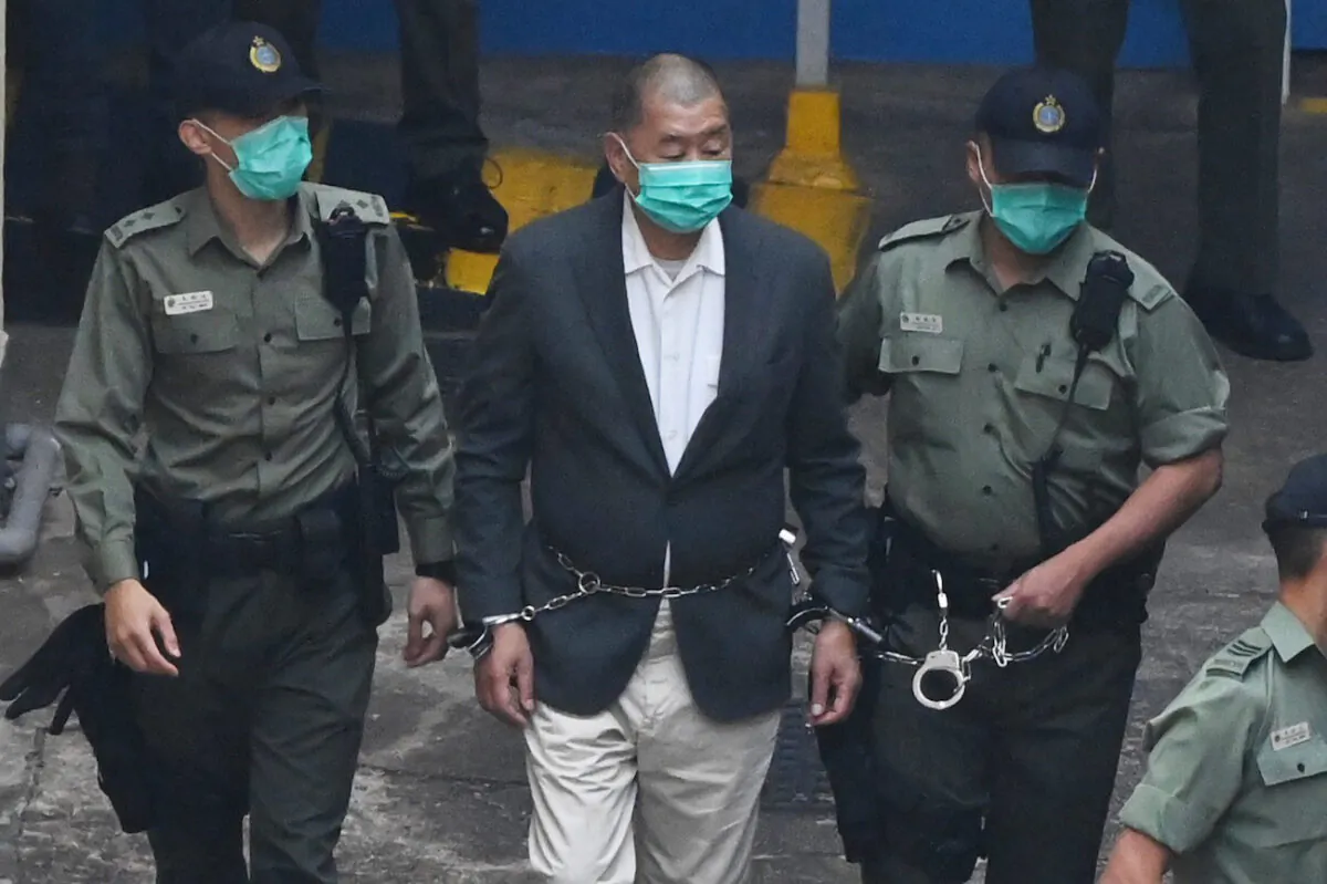 Hong Kong pro-democracy media tycoon Jimmy Lai is led into a police van as he heads to court to be charged under the Beijing-imposed draconian new national security law, on Dec. 12, 2020. (Peter Parks/AFP via Getty Images)