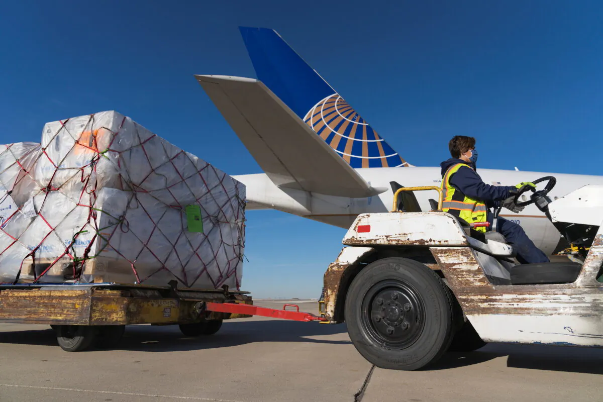 A shipment of Pfizer's COVID-19 vaccines is unloaded from a United Airlines cargo-only flight from Brussels to O'Hare International Airport in Chicago, on Dec. 2, 2020. (United Airlines via Reuters)