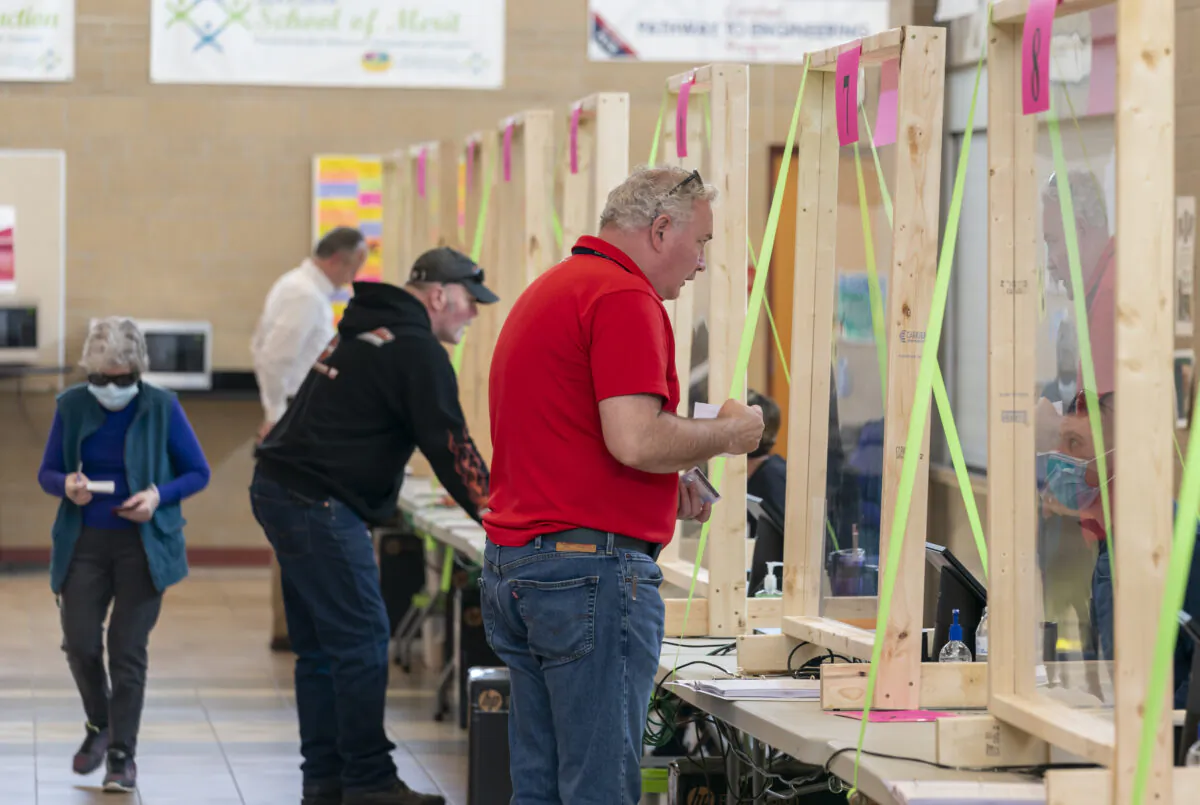 People check in to vote at a polling place in Sun Prairie, Wis., on April 7, 2020. (Andy Manis/Getty Images)