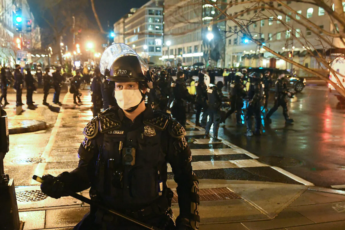 A police officer in riot gear stands guard as protesters gather near Black Lives Matter Plaza during a protest in Washington on Dec. 12, 2020. (Stephanie Keith/Getty Images)