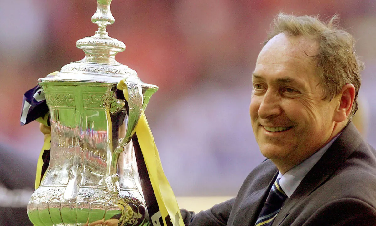 Liverpool manager Gerard Houllier holds aloft the FA Cup at the Millennium Stadium, Cardiff, Britain, on May 12, 2001. (Ian Hodgson/Reuters)